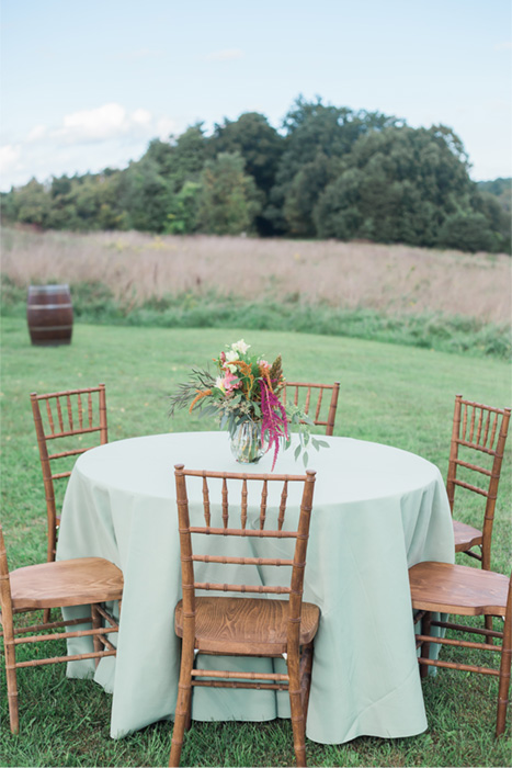 Delicately arranged centerpiece of wildflowers are on display on a wedding reception table at Mohonk Preserve