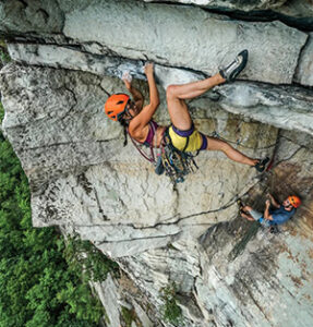 Rock climber in the gunks on Erect Direction (5.10c)