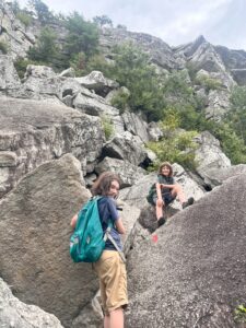 Campers climbing a rock scramble among the talus. 