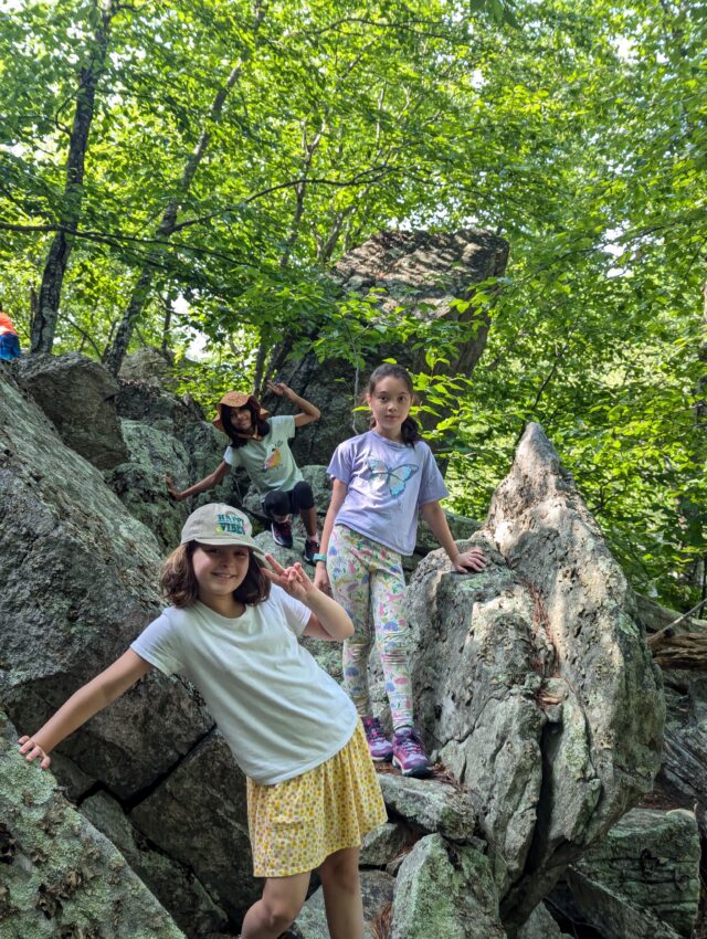 Campers posing on rock talus